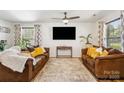 Comfortable living room featuring two brown leather sofas, a decorative rug and an entertainment center at 925 Skywatch Ln, Monroe, NC 28112