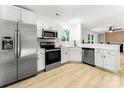 Modern kitchen with stainless steel appliances, white cabinets, and beautiful countertops at 9513 Saddle Run Trl, Charlotte, NC 28269