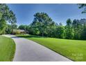 Long driveway leading to the brick home, surrounded by a beautifully maintained lawn and mature trees at 103 3Rd Sw St, Catawba, NC 28609