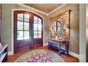 Foyer features a wooden console table with lamps, mirror, area rug and wood framed glass paneled doors at 103 3Rd Sw St, Catawba, NC 28609