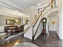 Spacious foyer with hardwood floors, staircase, and view into the formal dining room at 105 Beech Bluff Dr, Mount Holly, NC 28120