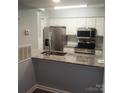 Kitchen features stainless steel appliances, granite countertops and white cabinets at 11010 Harrowfield Rd, Charlotte, NC 28226