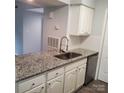 Bright kitchen with granite countertops, stainless steel sink, and updated faucet at 11010 Harrowfield Rd, Charlotte, NC 28226
