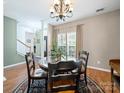 Elegant dining area with round table, chandelier, and large windows at 11909 Creek Turn Dr, Charlotte, NC 28278