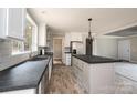 Charming kitchen with stainless appliances, island with a black countertop and modern lighting at 122 River Ridge Ln, Hickory, NC 28601
