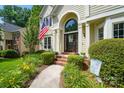 Inviting front entrance with brick steps and beautiful landscaping at 12712 Hollyhock Ln, Huntersville, NC 28078