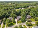 Aerial view of a wooded neighborhood with well-maintained homes and lush greenery at 1336 Dobson Dr, Waxhaw, NC 28173