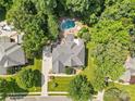 Overhead view of a home with a pool, patio, manicured lawn, and mature trees at 1336 Dobson Dr, Waxhaw, NC 28173
