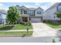 Beautiful home with a well-maintained lawn, spacious driveway, and classic architectural details at 15018 Marymont Ave, Huntersville, NC 28078