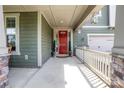 Inviting front porch with stylish lighting and a classic red front door at 15018 Marymont Ave, Huntersville, NC 28078