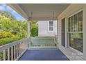 Cozy front porch featuring a classic porch swing, offering a relaxing outdoor space at 1600 Onslow Dr, Charlotte, NC 28205