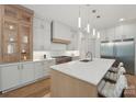 This modern kitchen features an island, stainless steel appliances, and custom cabinets at 213 Crest Ct, Weddington, NC 28104