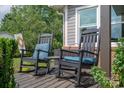 Cozy front porch featuring two rocking chairs with comfortable cushions, creating a perfect spot for relaxation at 2206 Whitworth Rd, Cherryville, NC 28021
