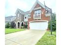 Beautiful home featuring a well-manicured lawn, a basketball hoop, and an attached two car garage at 2634 Treeline Dr, Concord, NC 28027