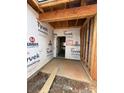 Unfinished garage interior with concrete floor, exposed studs, and Tyvek house wrap at 2735 Primrose Ave, Charlotte, NC 28208
