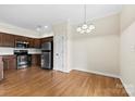 Well-lit kitchen with stainless steel appliances, and wood floors at 2765 Clover Nw Rd, Concord, NC 28027