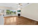 The living room is bright, with a fireplace, hardwood flooring, and a ceiling fan at 2765 Clover Nw Rd, Concord, NC 28027