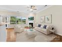 Bright living room with large windows, a fireplace, and stylish modern decor at 2765 Clover Nw Rd, Concord, NC 28027