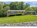 Inviting two-story home with lush green lawn, a carport, and a cozy front entrance at 3269 Tolley St, Claremont, NC 28610