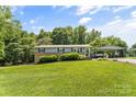 Welcoming home with verdant lawn, a convenient carport, and a charming front door at 3269 Tolley St, Claremont, NC 28610