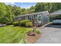 Well-kept home featuring charming landscaping, a cozy front porch and a covered carport at 3269 Tolley St, Claremont, NC 28610