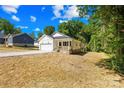 Exterior view of a charming white single-Gathering home with an attached garage and manicured lawn at 332 Hollingswood Dr, Statesville, NC 28625