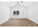 Bright, empty living room features high ceilings, wood-look flooring, and large windows at 332 Hollingswood Dr, Statesville, NC 28625