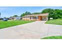 Brick home with an expansive driveway and well-manicured lawn at 3413 Fallston Rd, Shelby, NC 28150