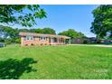 Traditional brick home featuring a green lawn and inviting covered entry at 3413 Fallston Rd, Shelby, NC 28150