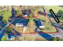 Aerial view showcasing the property's layout, trees, and road access at 456 Cornelius Rd, Mooresville, NC 28117