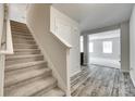 Carpeted staircase leading to the second floor, complemented by gray walls and wood-look flooring at 463 W Barr St, Lancaster, SC 29720