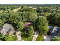 An aerial shot of the house with beautiful landscaping and mature trees that provide plenty of privacy at 5310 Addington Ct, Charlotte, NC 28277
