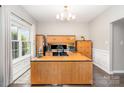 Bright office features a large desk, built-in storage, and a sun-filled window at 5723 Lindley Crescent Dr, Indian Trail, NC 28079