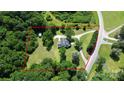 Aerial view of a home surrounded by lush trees and an expansive yard, with a driveway at 604 Ferguson Ridge Rd, Gastonia, NC 28052