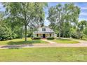 Beautifully landscaped property featuring a classic white farmhouse with a welcoming front porch at 604 Ferguson Ridge Rd, Gastonia, NC 28052