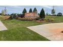 Community entrance sign with lush landscaping and a well-maintained lawn at 7220 Hodges Meadow Ln, Charlotte, NC 28213
