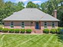 Charming brick home featuring a well-manicured front lawn and mature landscaping at 733 Killian Rd, Stanley, NC 28164