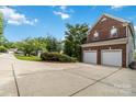 Brick home with a two-car garage and spacious driveway at 7704 Ninth Fairway Ln, Mint Hill, NC 28227