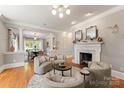 Elegant living room features a fireplace and plenty of natural light at 901 Hartford Ave, Charlotte, NC 28209