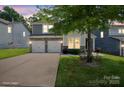 Attractive two-story home with a two-car garage and landscaped yard; virtually staged to show potential at 10012 Michael Crossing Dr, Charlotte, NC 28213