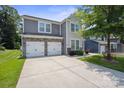 Lovely two-story home with a two-car garage, stone accents, and a well-manicured lawn at 10012 Michael Crossing Dr, Charlotte, NC 28213