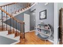 Inviting foyer featuring hardwood floors, staircase with decorative iron railing, and stylish decor at 107 Glenmont Ct, Mooresville, NC 28117