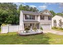 Charming two-story home with landscaped yard, white fence and fountain feature enhancing curb appeal at 10816 Pointer Ridge Dr, Charlotte, NC 28214