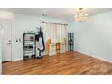 Open living room with hardwood floors, chandelier, and a view of the front door at 10816 Pointer Ridge Dr, Charlotte, NC 28214