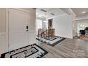 Elegant dining area featuring wood floors, stylish rug, and modern lighting fixture at 1195 Cavalier Ln, Rock Hill, SC 29730