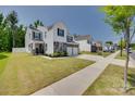 Well-maintained home with a green lawn, long driveway and welcoming curb appeal in quiet neighborhood at 1195 Cavalier Ln, Rock Hill, SC 29730