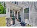 Inviting front porch with stone accents, decorative plants, and a well-lit entrance at 1195 Cavalier Ln, Rock Hill, SC 29730