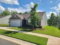 A well-maintained house showing a lovely lawn, complemented by blue skies with puffy clouds at 1195 Winding Creek Rd, Salisbury, NC 28146