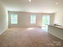 An expansive living room bathed in natural light, featuring a cozy carpet and an open layout at 1195 Winding Creek Rd, Salisbury, NC 28146