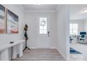 Welcoming foyer boasts a white bench, coat rack, and durable laminate flooring at 12024 John Newton Dr, Davidson, NC 28036